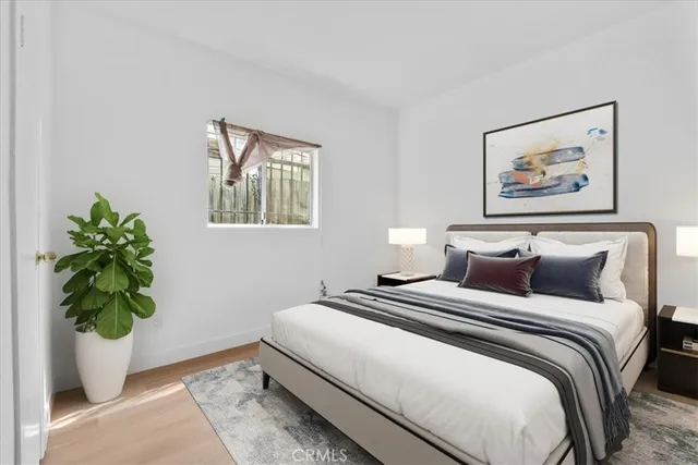 a bedroom with bed and a potted plant