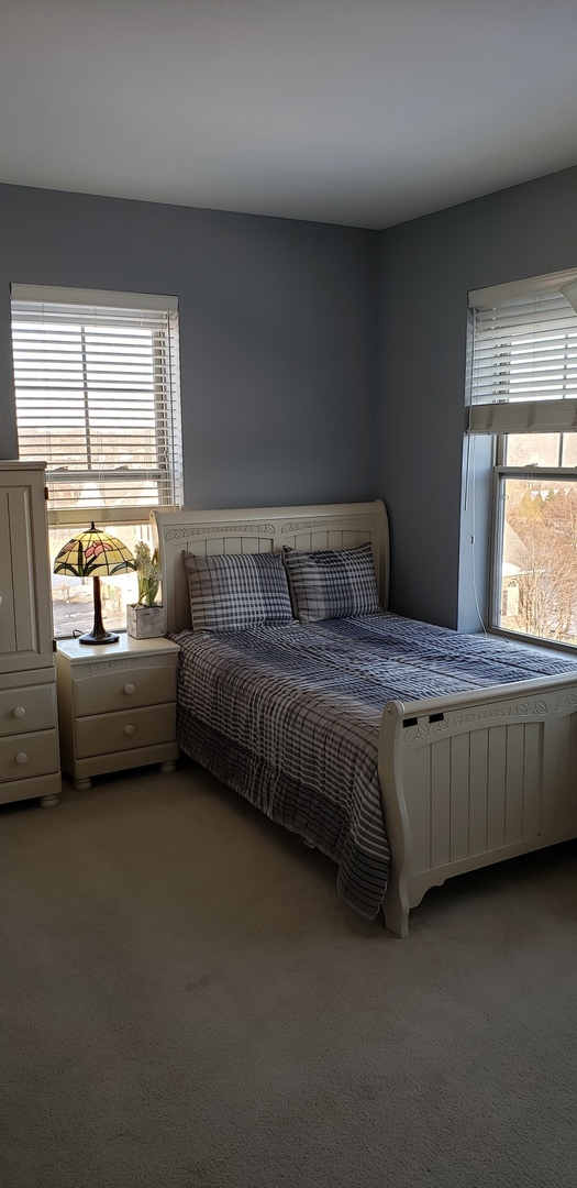 511 Prestwick Lane, Unit 501 Wheeling, IL 60090 - Photo 12 of 21 a bedroom with a bed and a window