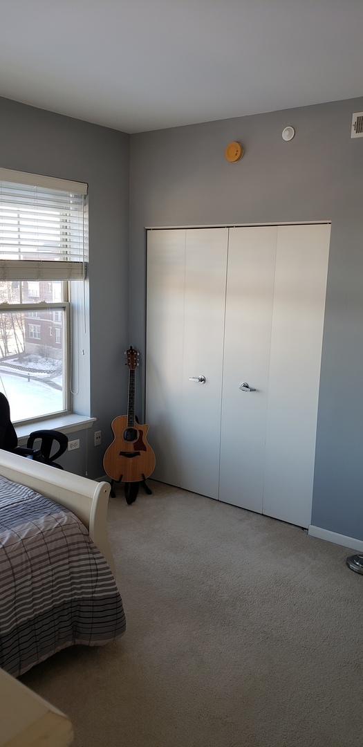 511 Prestwick Lane, Unit 501 Wheeling, IL 60090 - Photo 13 of 21 a bedroom with bed and window