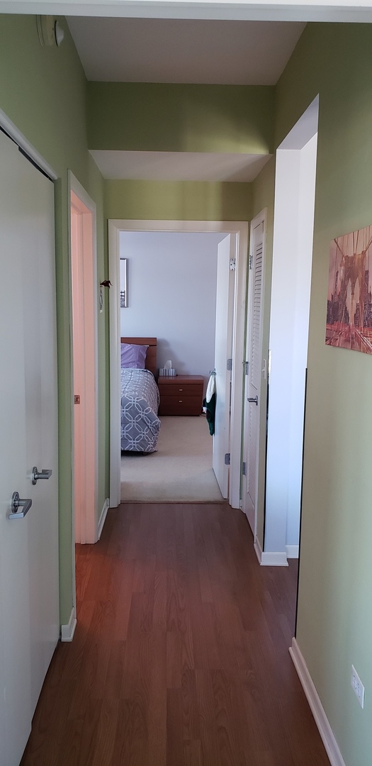 511 Prestwick Lane, Unit 501 Wheeling, IL 60090 - Photo 14 of 21 a bedroom with a bed and a painting on the wall