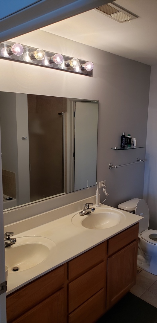 511 Prestwick Lane, Unit 501 Wheeling, IL 60090 - Photo 17 of 21 a bathroom with a sink and a mirror