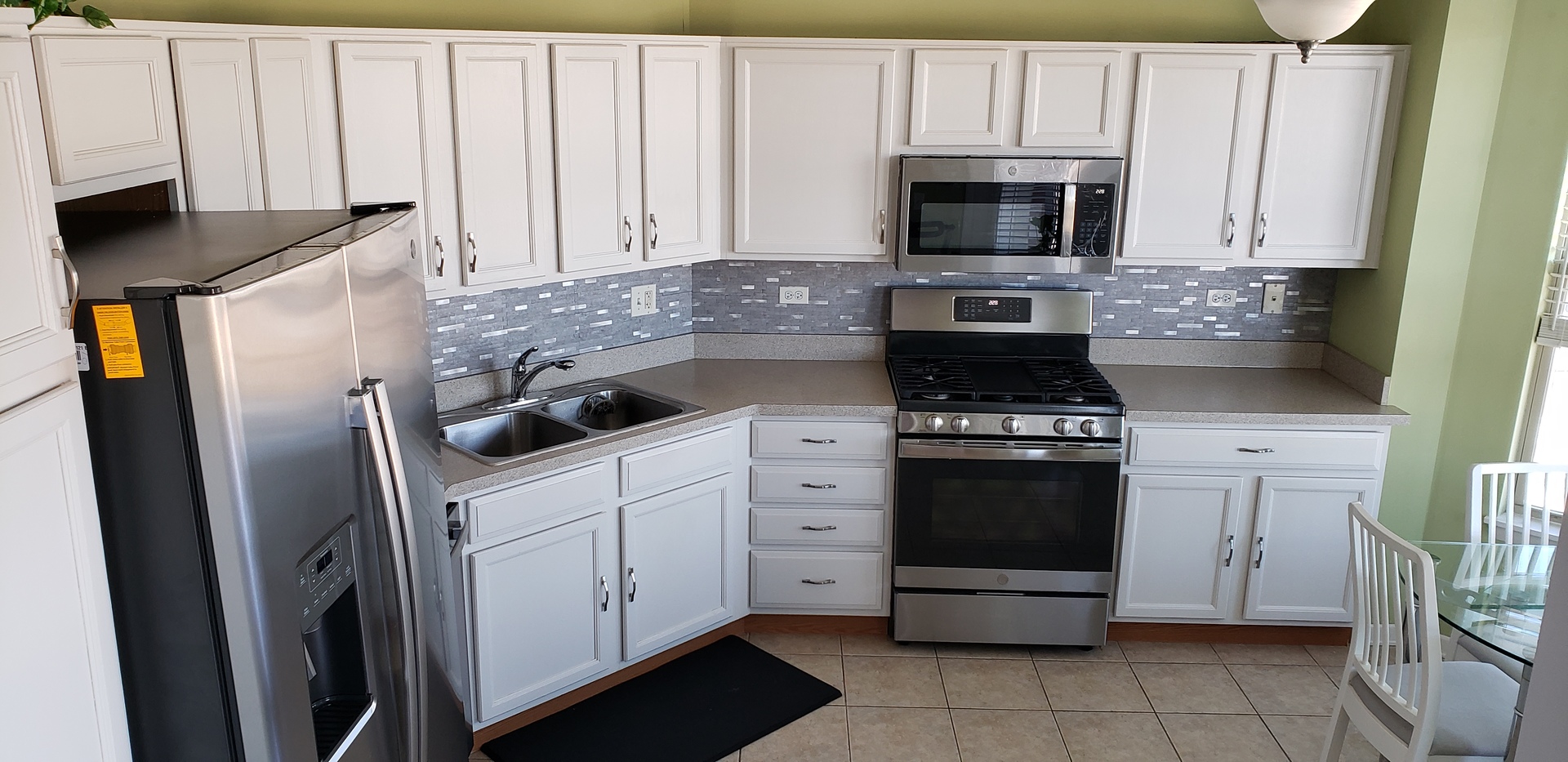 511 Prestwick Lane, Unit 501 Wheeling, IL 60090 - Photo 5 of 21 a kitchen with white cabinets and stainless steel appliances