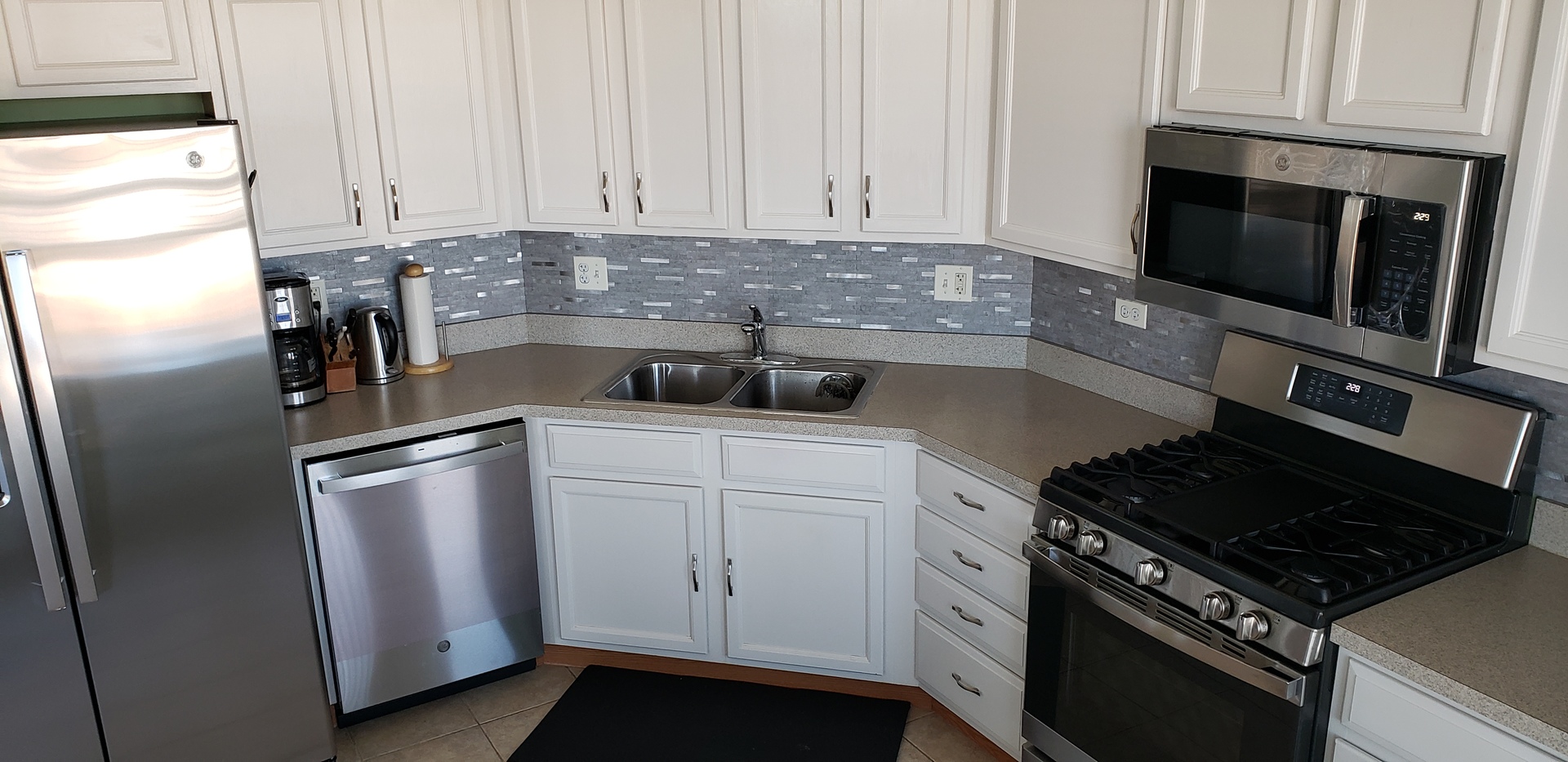 511 Prestwick Lane, Unit 501 Wheeling, IL 60090 - Photo 6 of 21 a kitchen with stainless steel appliances granite countertop a stove a refrigerator and a microwave