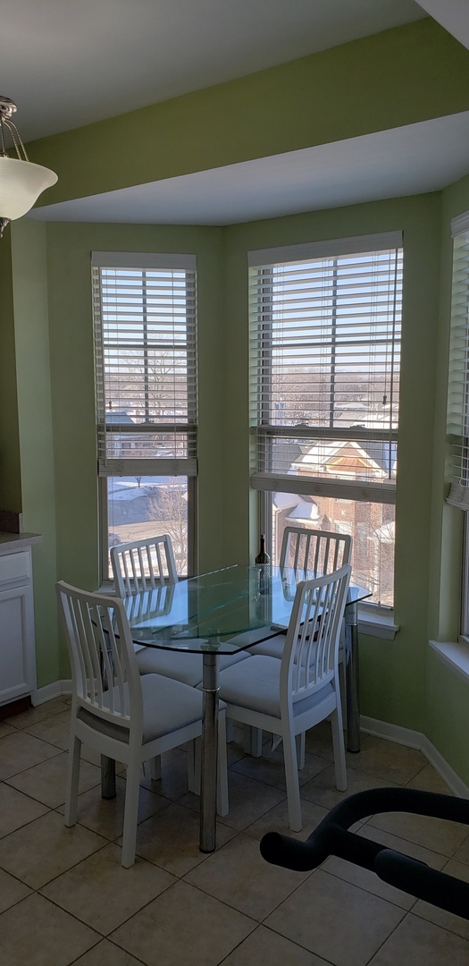 511 Prestwick Lane, Unit 501 Wheeling, IL 60090 - Photo 7 of 21 a view of a dining room with furniture and windows
