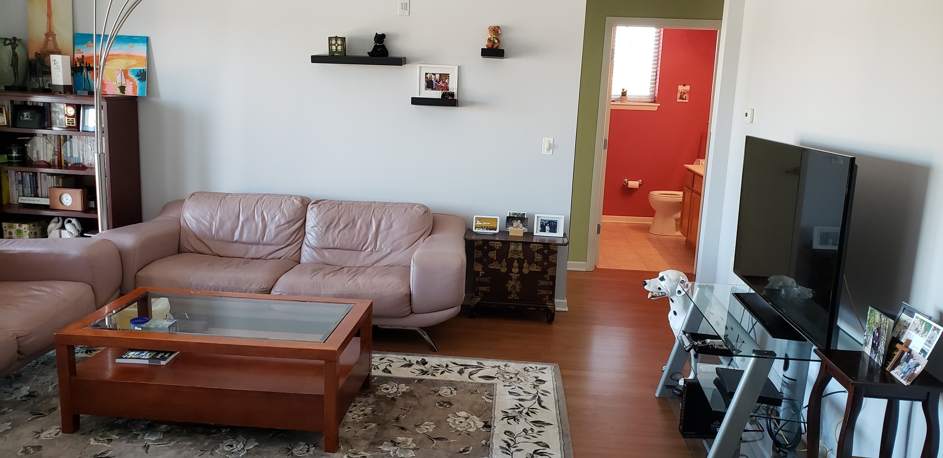 511 Prestwick Lane, Unit 501 Wheeling, IL 60090 - Photo 9 of 21 a living room with furniture a flat screen tv and a bookshelf