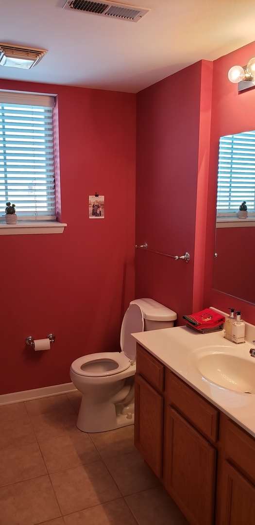 511 Prestwick Lane, Unit 501 Wheeling, IL 60090 - Photo 10 of 21 a bathroom with a granite countertop toilet and a sink