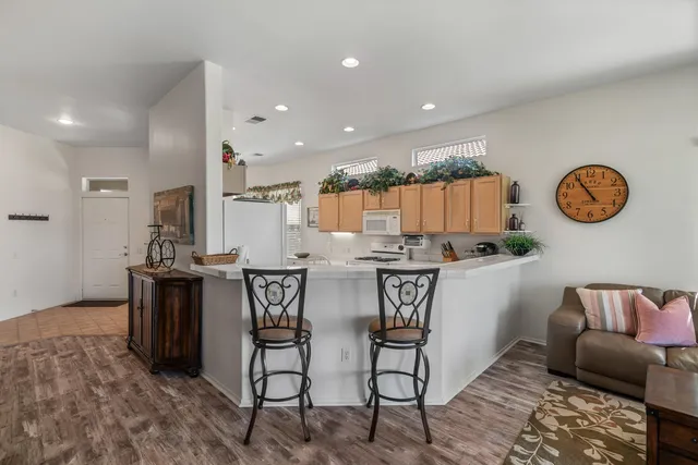 a kitchen with granite countertop white cabinets and white appliances