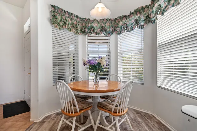 a dining room with furniture and a potted plant