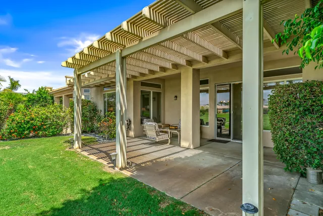 a patio with garden area and outdoor seating