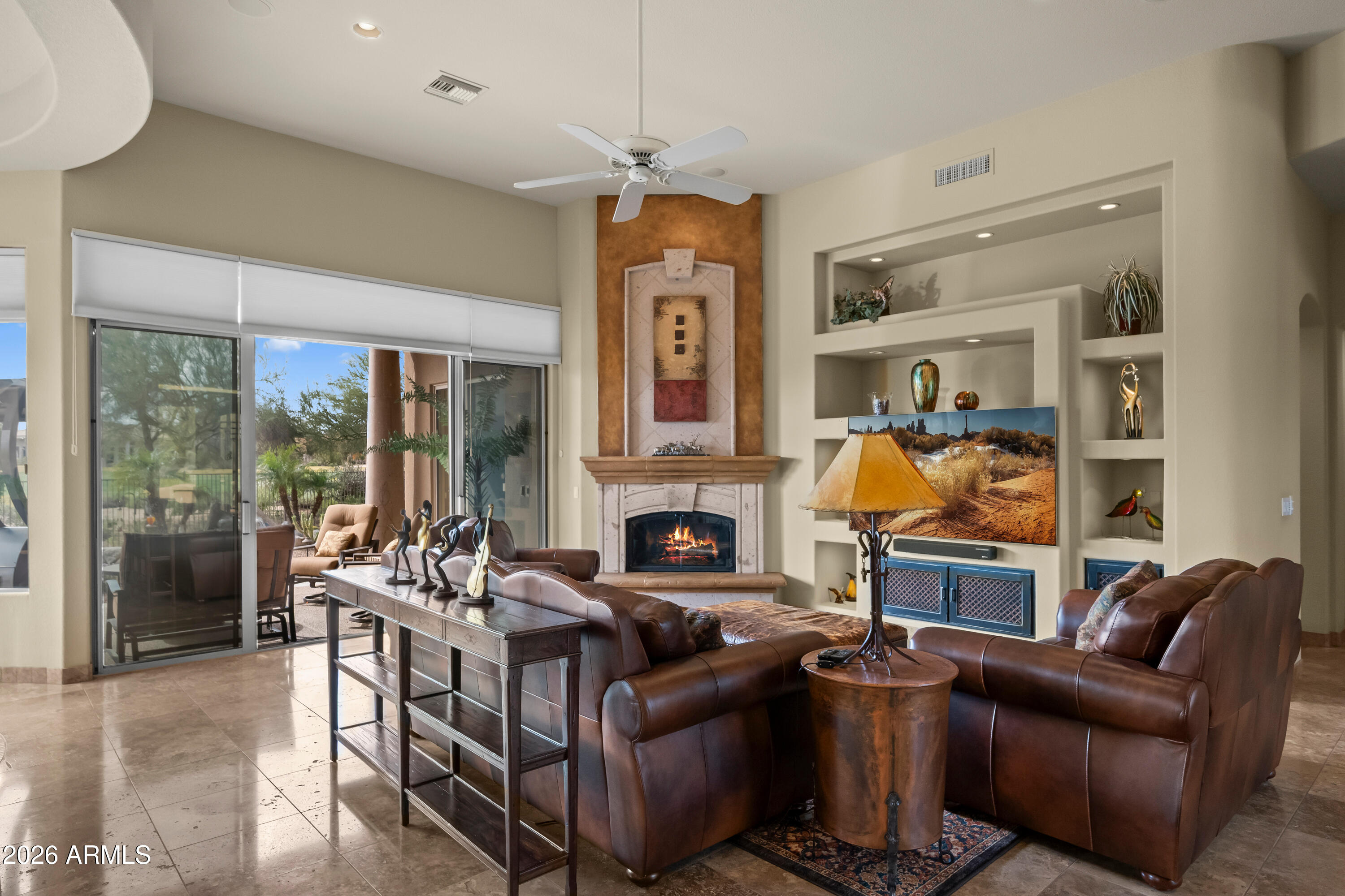18513 East Agua Verde Drive Rio Verde, AZ 85263 - Photo 11 of 42 a living room with furniture a fireplace and a chandelier