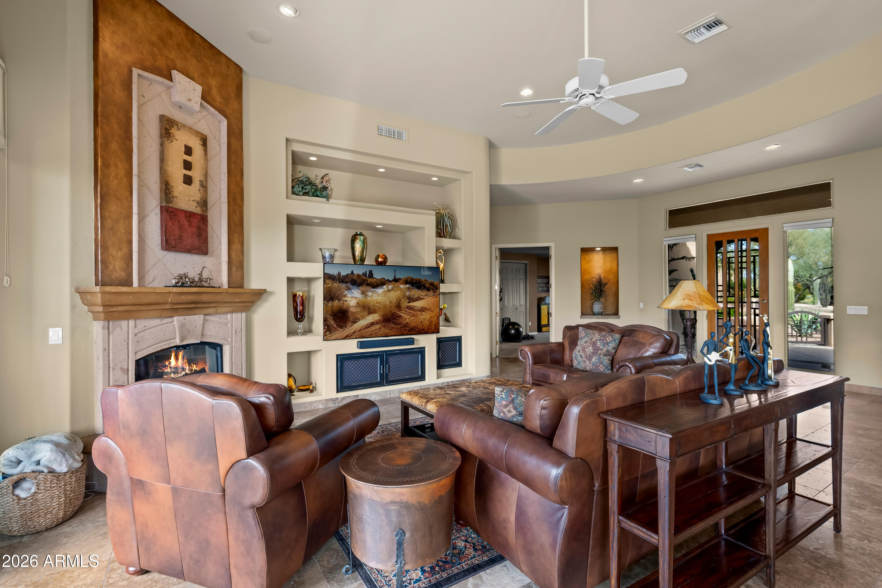 18513 East Agua Verde Drive Rio Verde, AZ 85263 - Photo 12 of 42 a living room with fireplace furniture and a view of kitchen