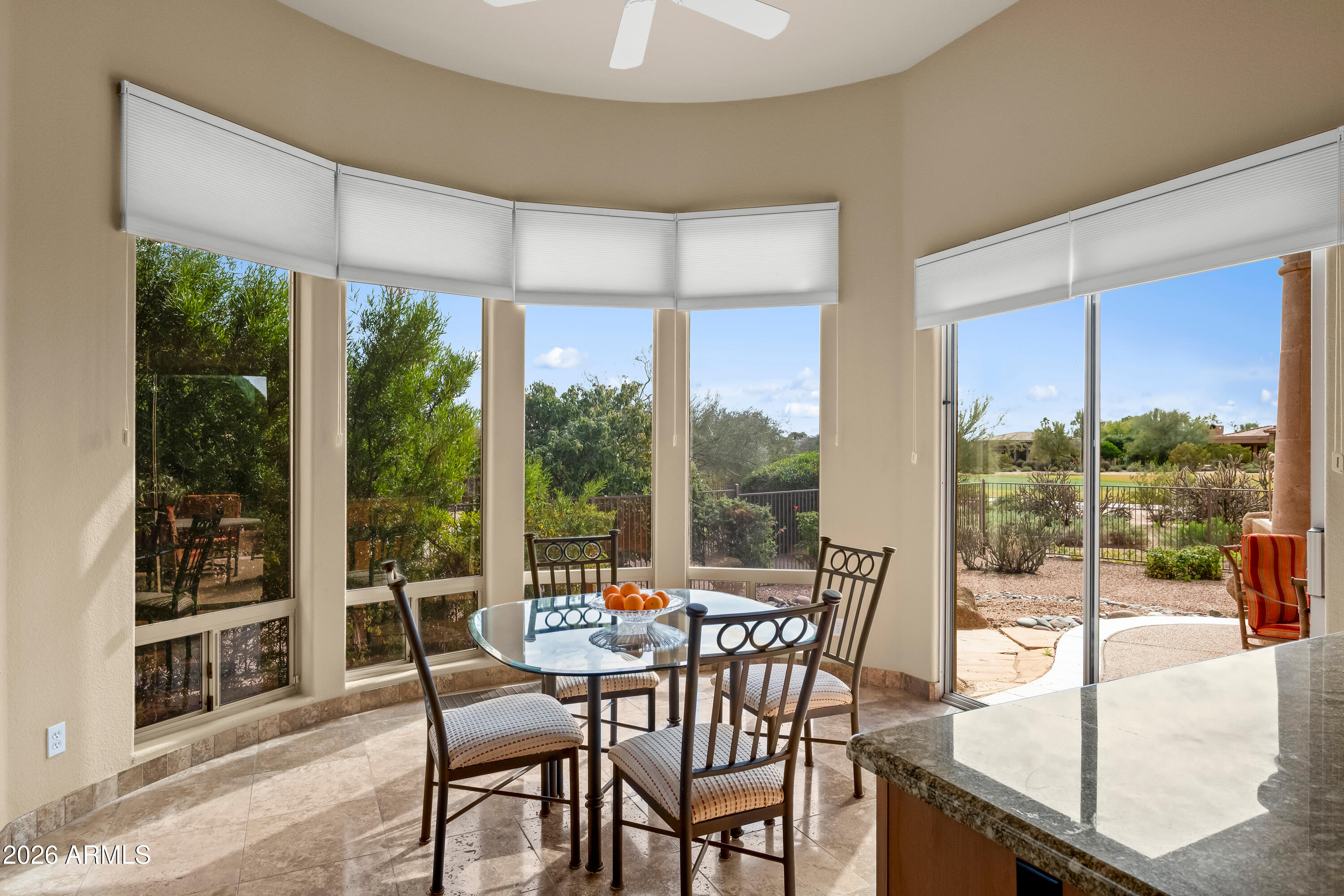 18513 East Agua Verde Drive Rio Verde, AZ 85263 - Photo 18 of 42 a dining room with furniture wooden floor and garden view