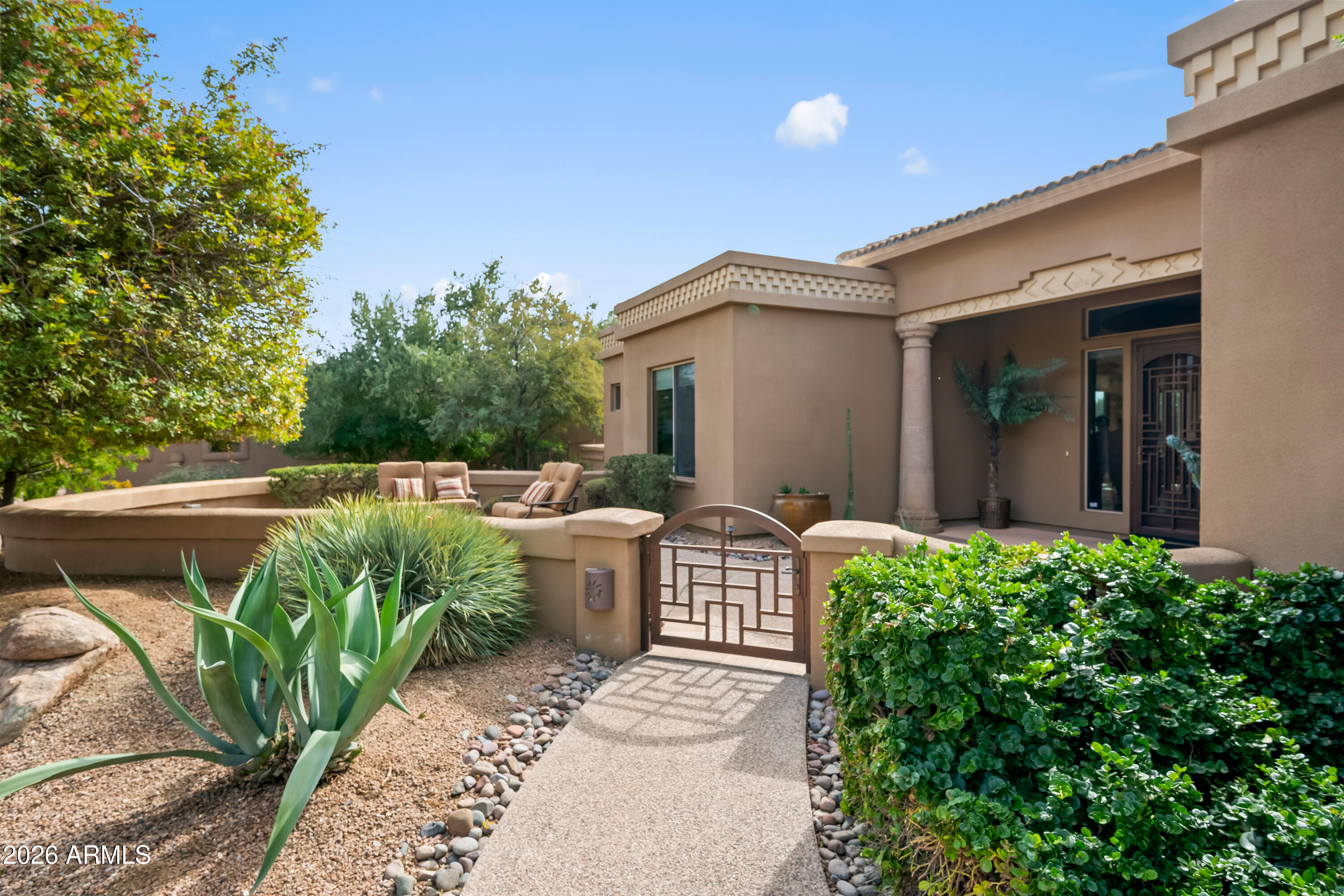 18513 East Agua Verde Drive Rio Verde, AZ 85263 - Photo 6 of 42 a view of a patio with table and chairs and potted plants