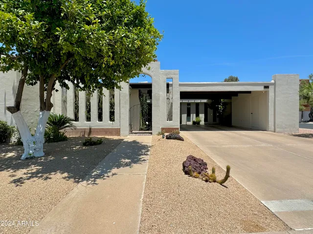 a view of a house with a yard and tree