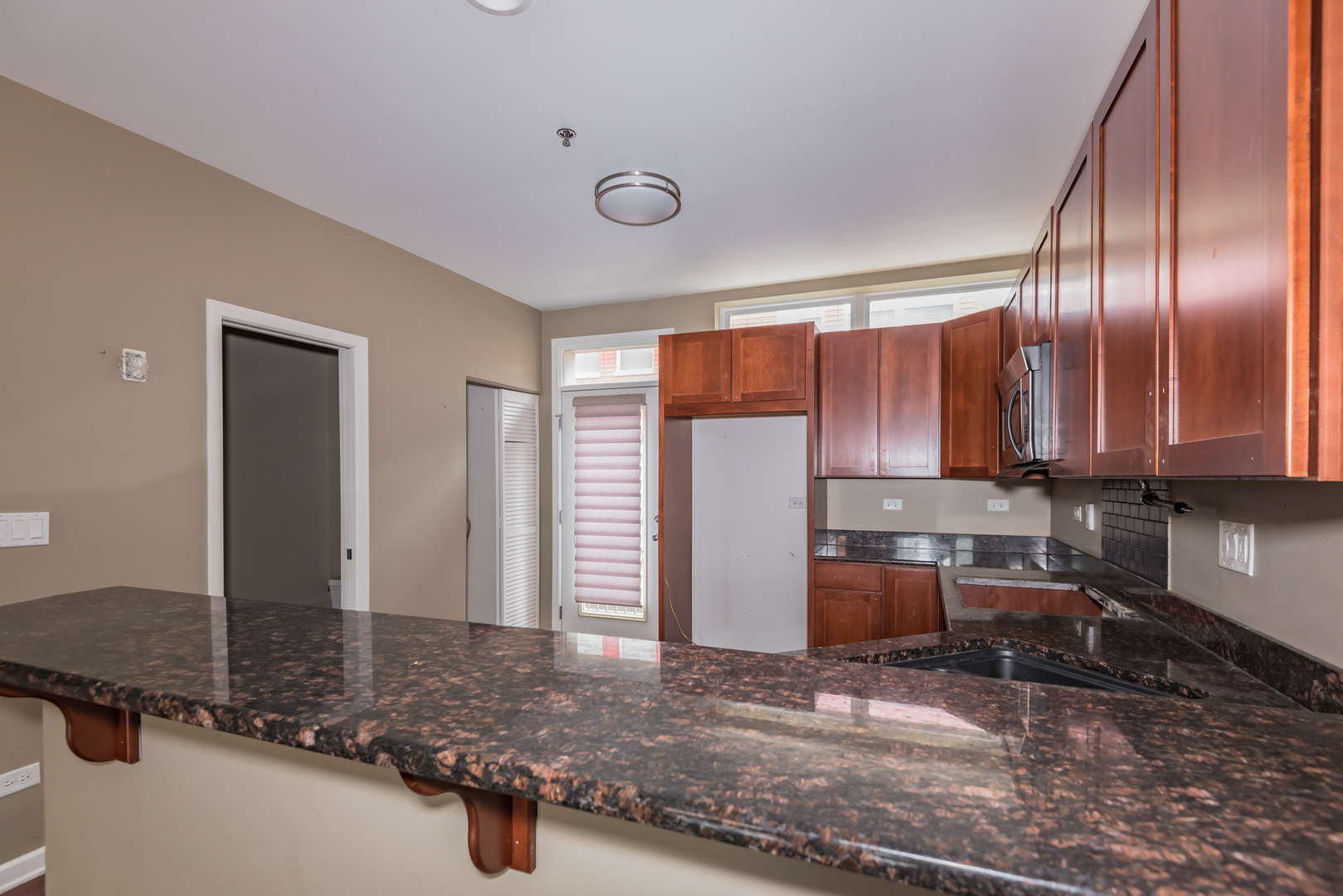 16 South Aberdeen Street, Unit 9 Chicago, IL 60607 - Photo 11 of 24 a view of a kitchen with a sink and cabinets