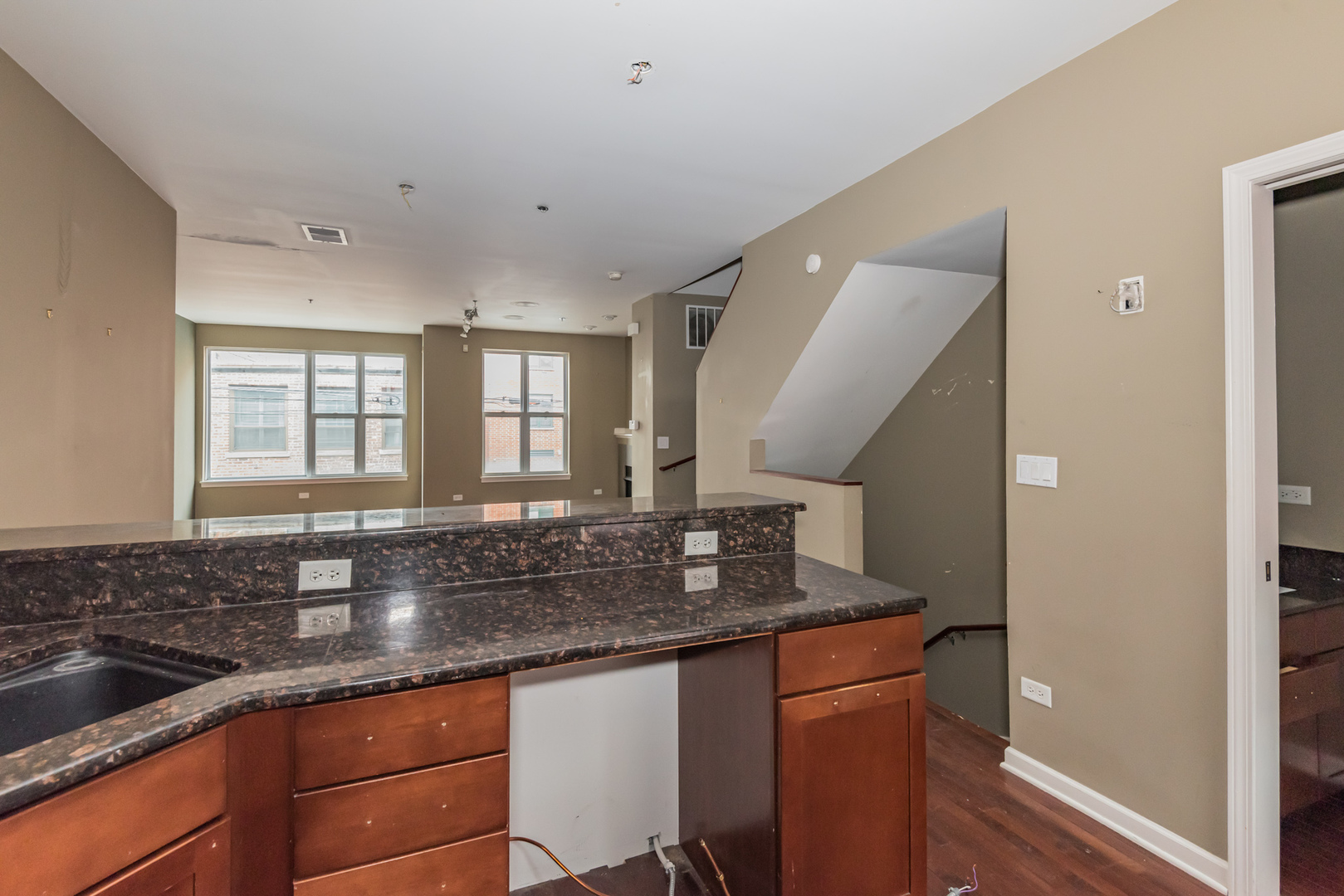 16 South Aberdeen Street, Unit 9 Chicago, IL 60607 - Photo 13 of 24 a kitchen with granite countertop a sink and a window