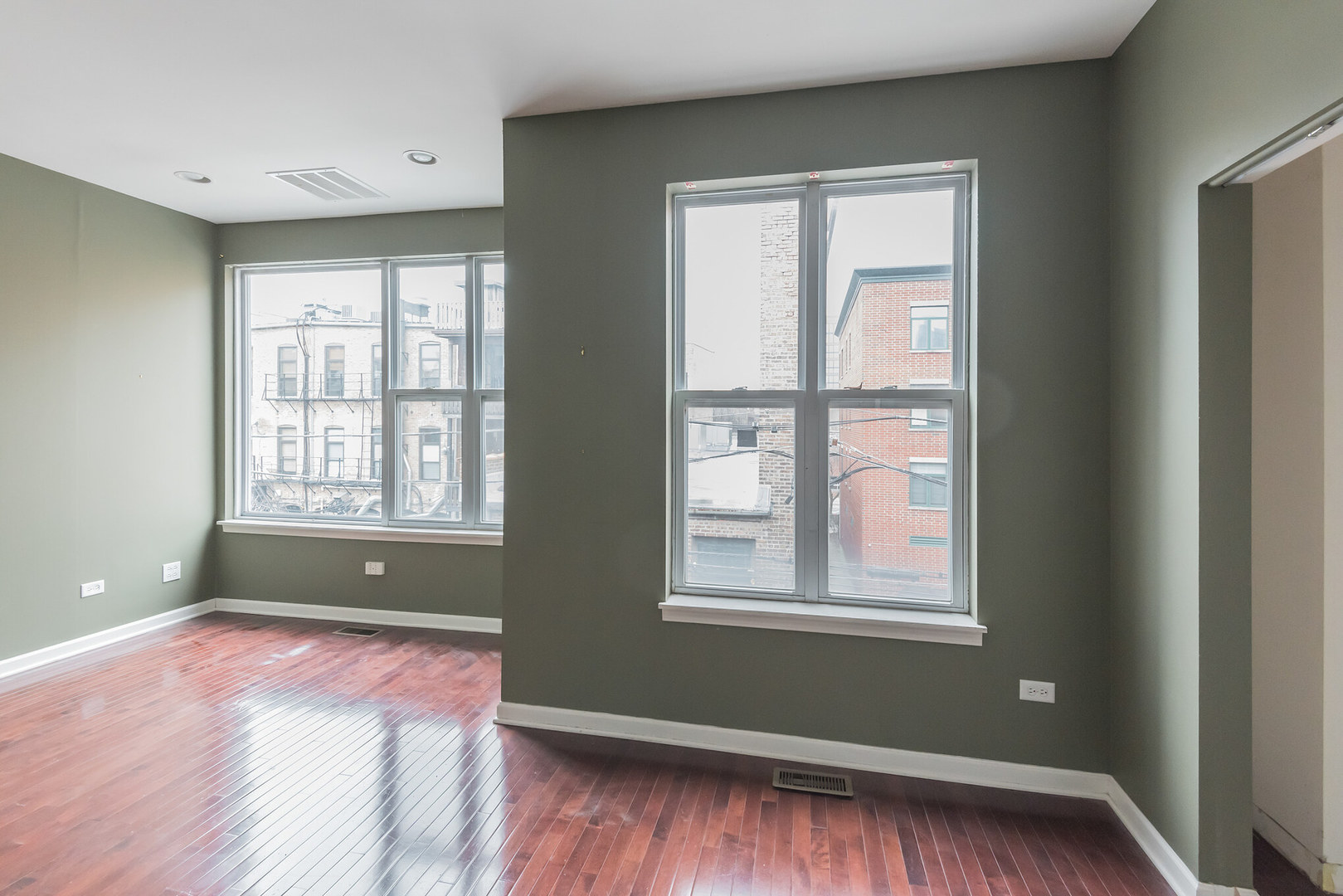 16 South Aberdeen Street, Unit 9 Chicago, IL 60607 - Photo 18 of 24 a view of room with window and wooden floor