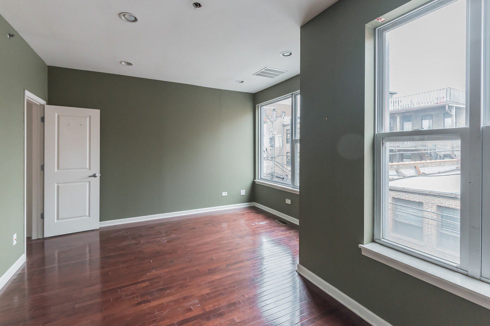 16 South Aberdeen Street, Unit 9 Chicago, IL 60607 - Photo 19 of 24 an empty room with wooden floor and windows