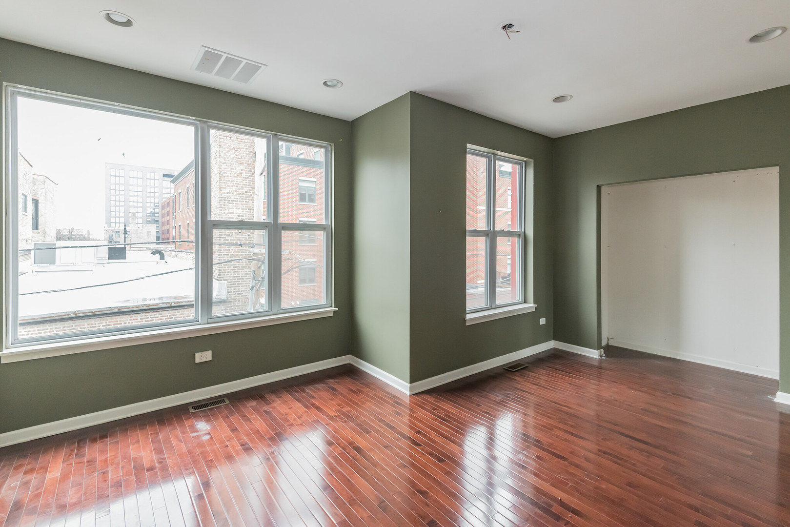 16 South Aberdeen Street, Unit 9 Chicago, IL 60607 - Photo 20 of 24 a view of an empty room with wooden floor and a window