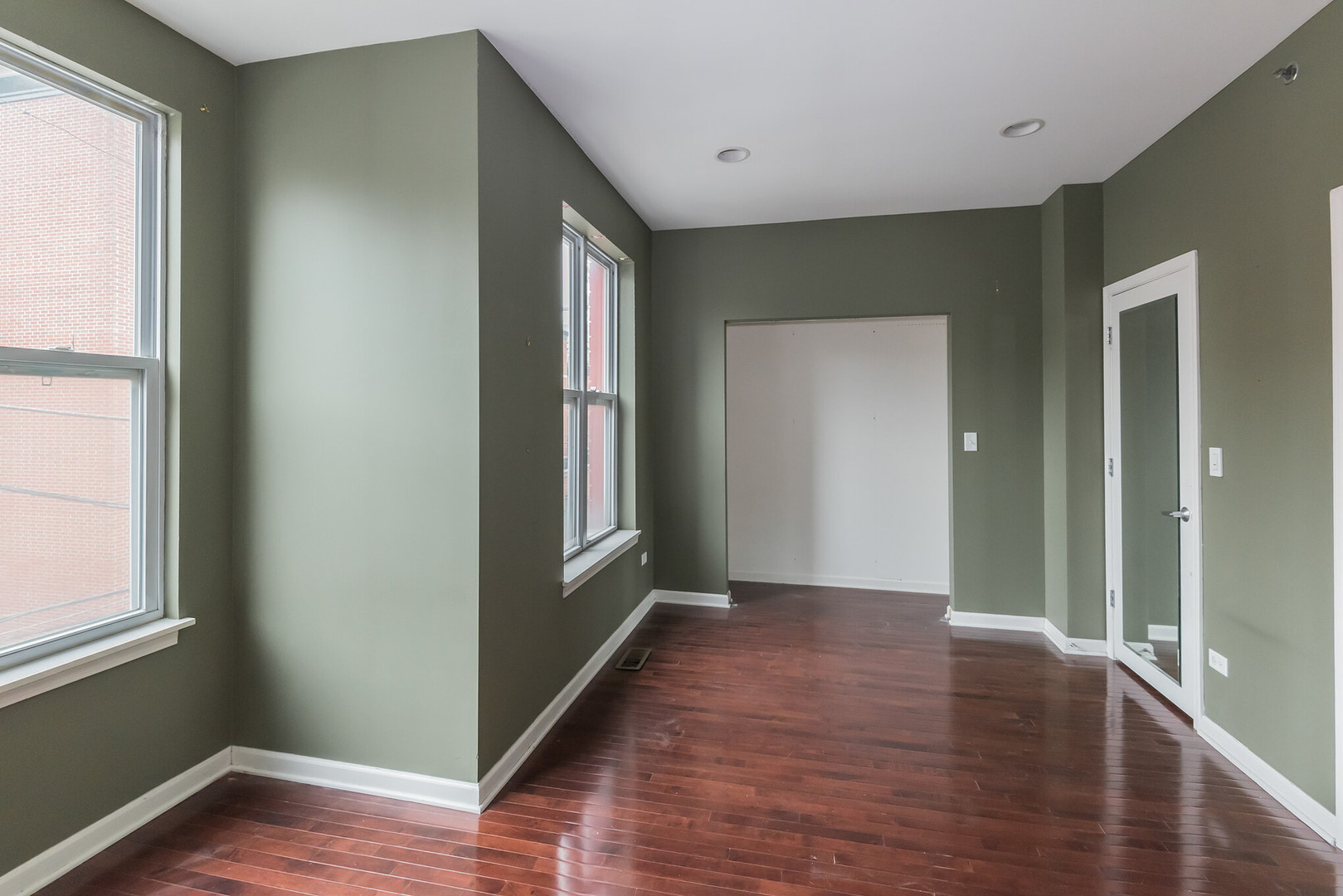16 South Aberdeen Street, Unit 9 Chicago, IL 60607 - Photo 21 of 24 a view of hallway with window and wooden floor