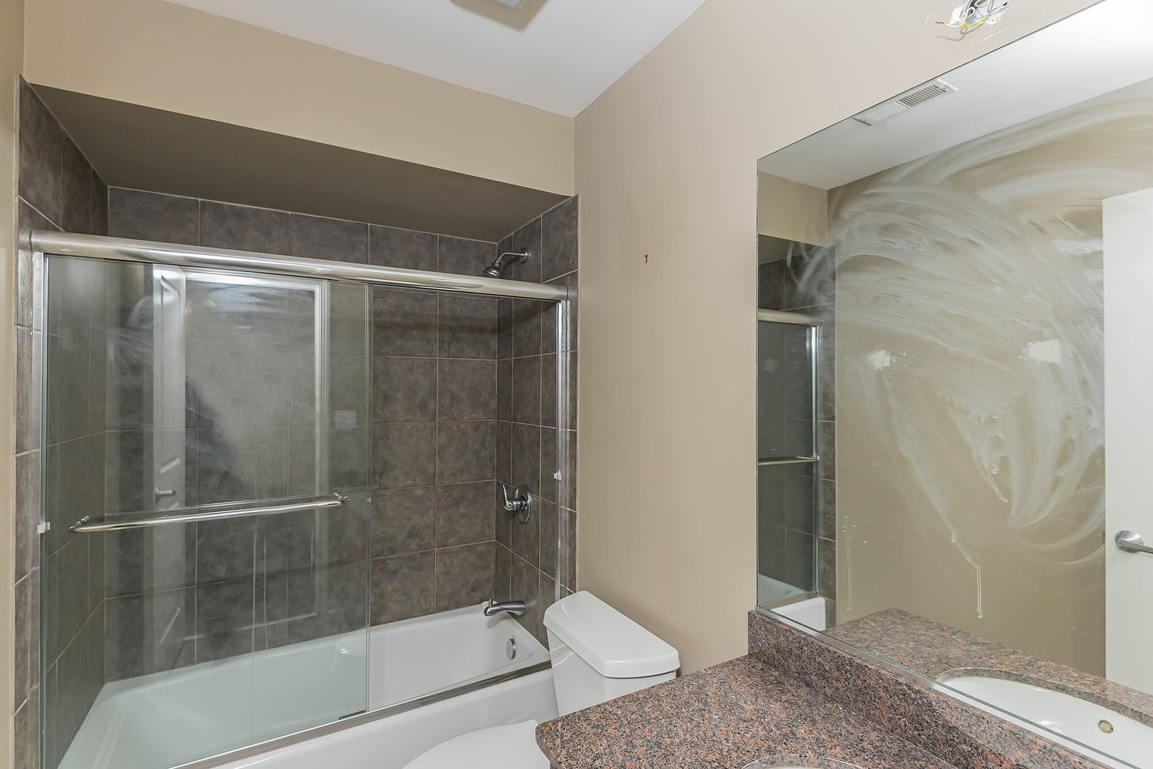 16 South Aberdeen Street, Unit 9 Chicago, IL 60607 - Photo 22 of 24 a bathroom with a granite countertop bathtub shower and toilet