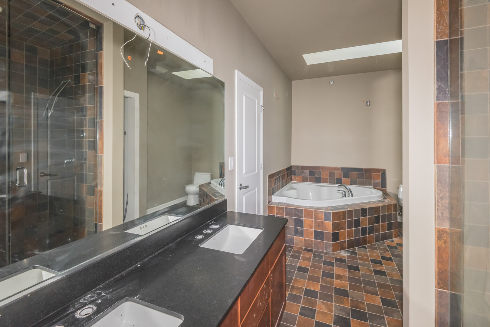 16 South Aberdeen Street, Unit 9 Chicago, IL 60607 - Photo 23 of 24 a bathroom with a sink and a mirror