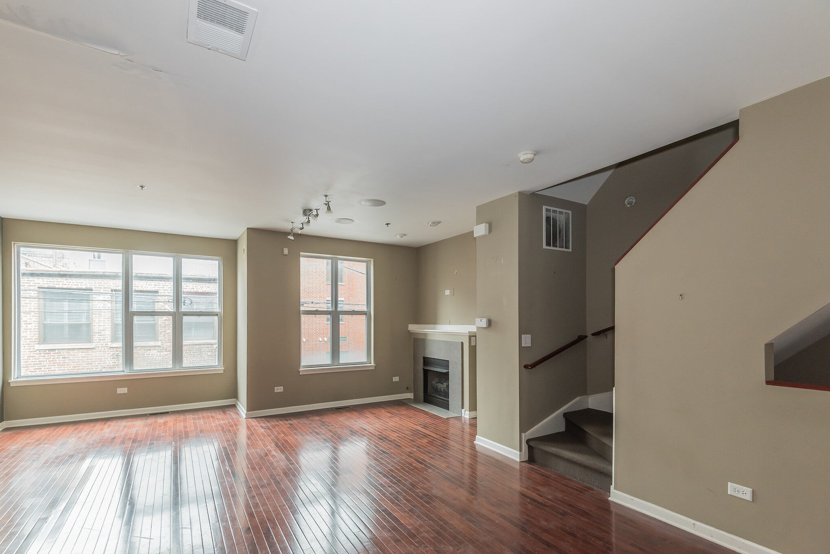 16 South Aberdeen Street, Unit 9 Chicago, IL 60607 - Photo 10 of 24 a view of an empty room with a window and wooden floor