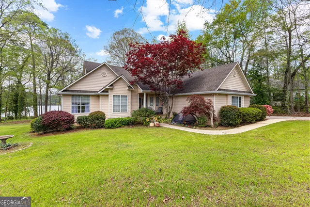 a view of a house with a yard and garage