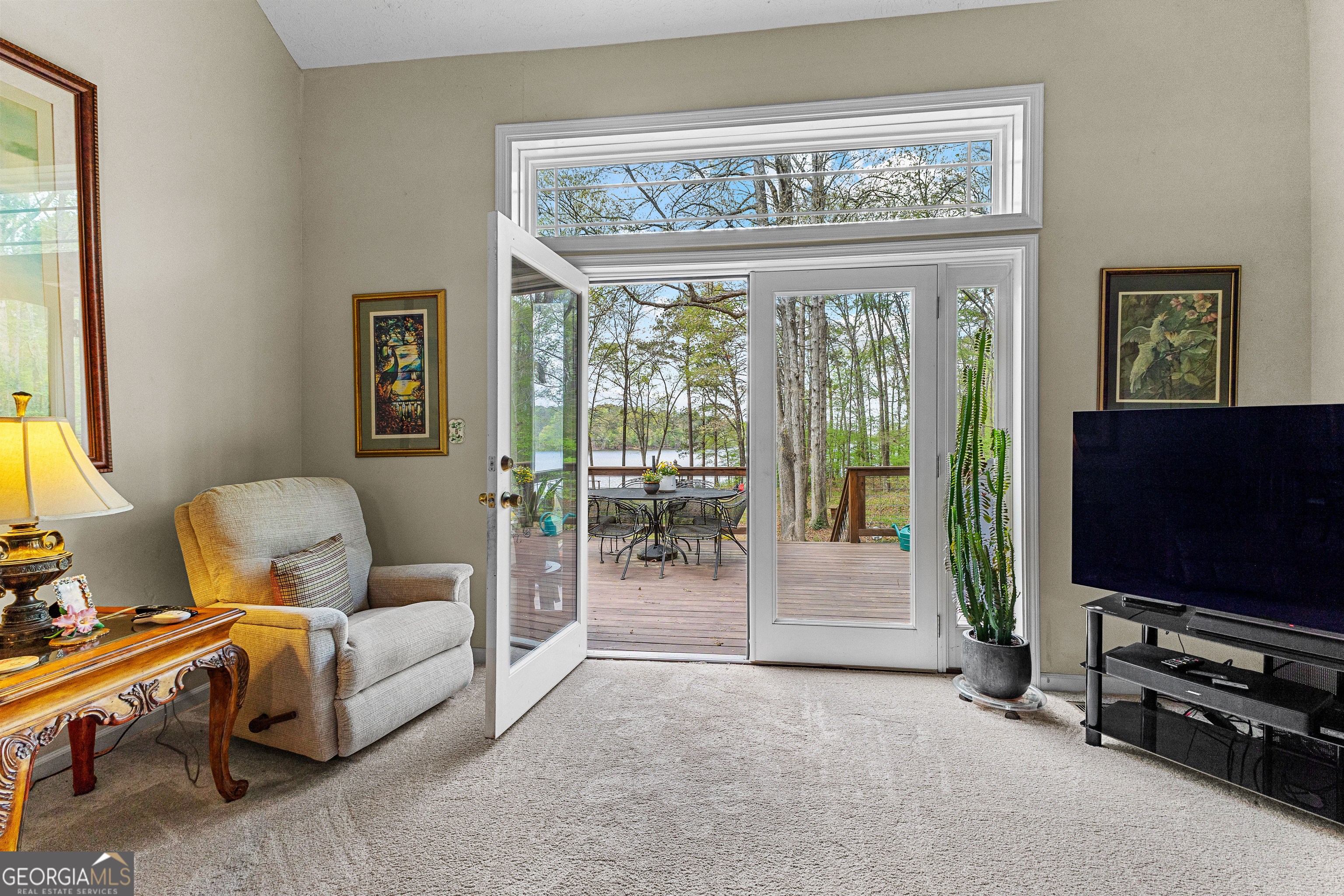 65 Pointe View Court Jackson, GA 30233 - Photo 15 of 39 a living room with furniture a flat screen tv and floor to ceiling window