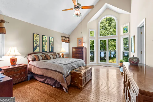 a spacious bedroom with a bed and a large window