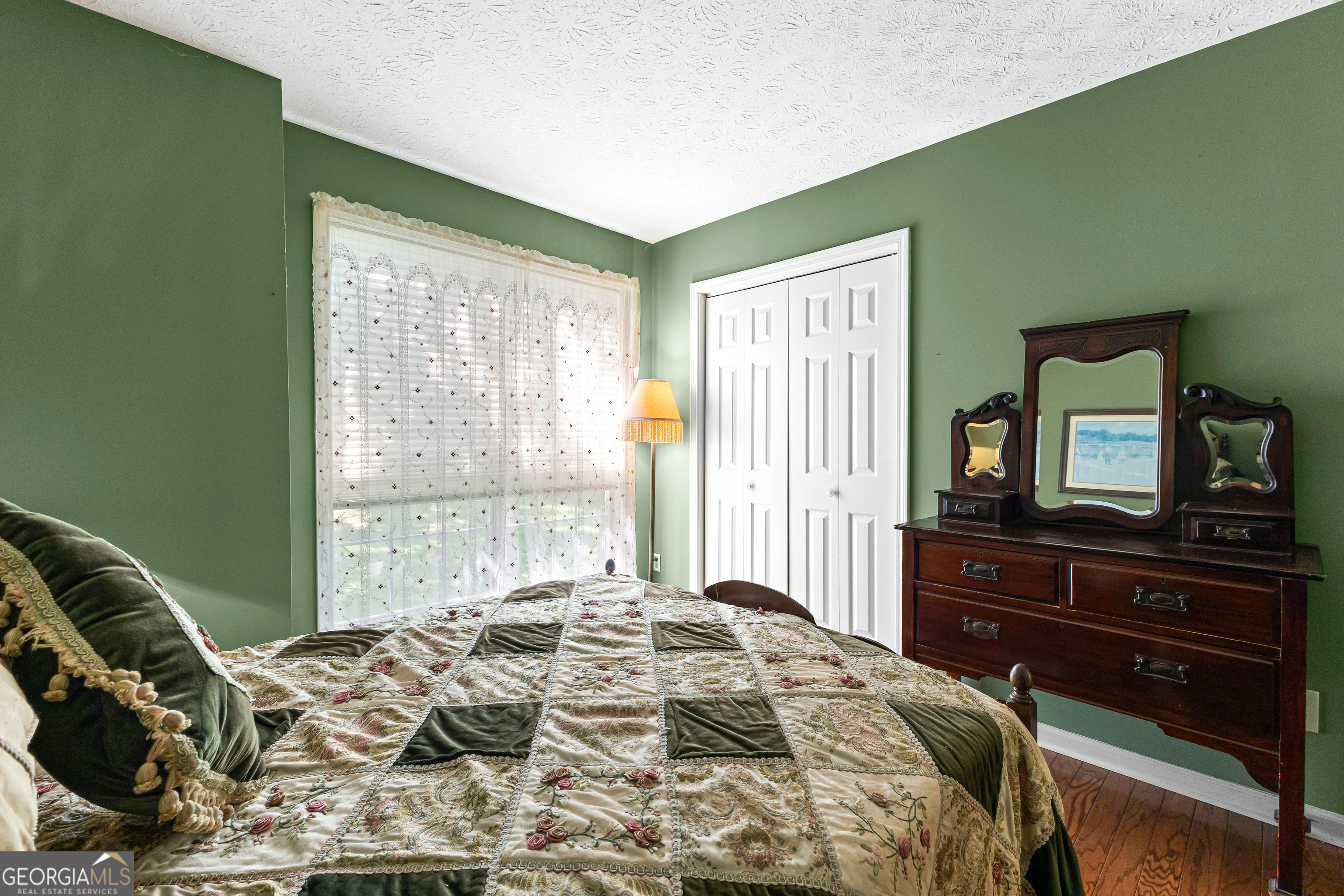 65 Pointe View Court Jackson, GA 30233 - Photo 22 of 39 a bedroom with a bed and a flat tv screen on dresser