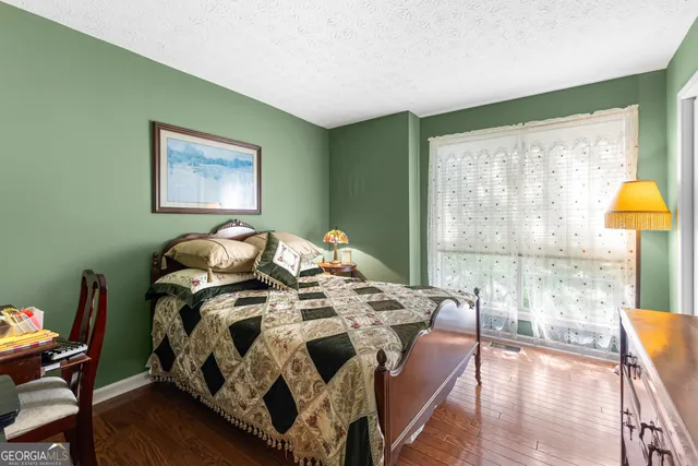 a bed sitting in a bedroom next to a window