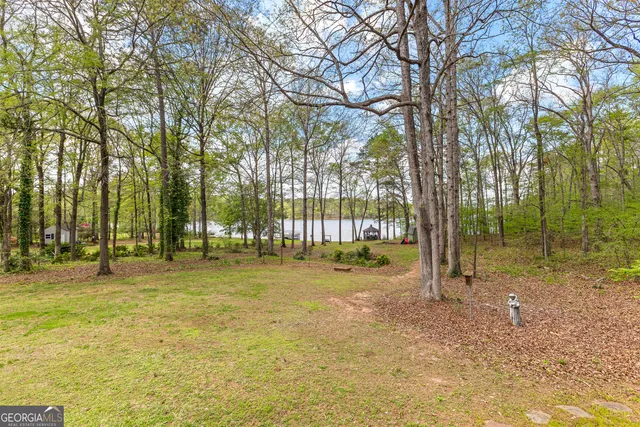 a swimming pool with trees in the background