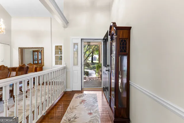 a view of hallway with wooden floor