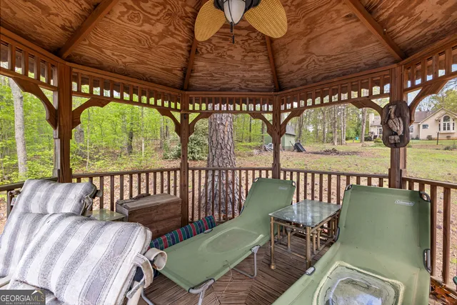 a view of porch with furniture and a patio
