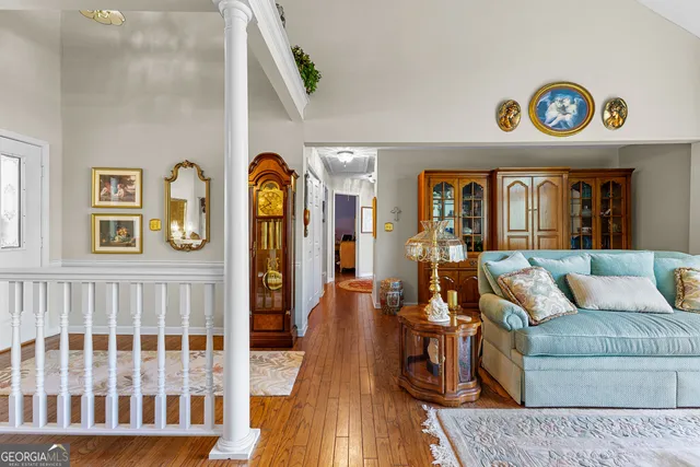 a living room with furniture and a wooden floor