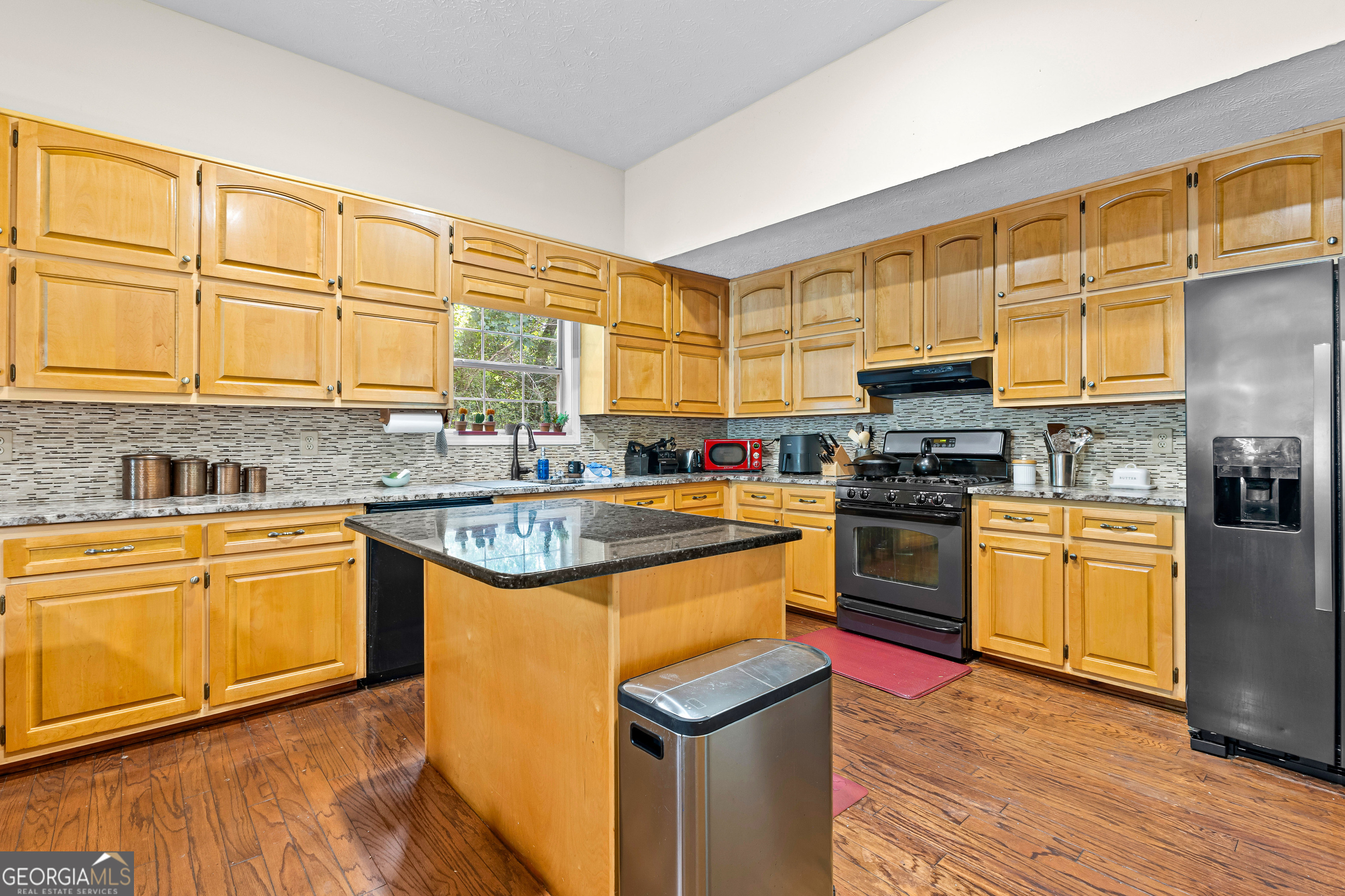 65 Pointe View Court Jackson, GA 30233 - Photo 10 of 39 a kitchen with stainless steel appliances granite countertop a stove a sink and a microwave