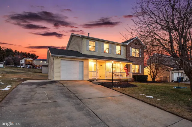 a front view of a building with a yard