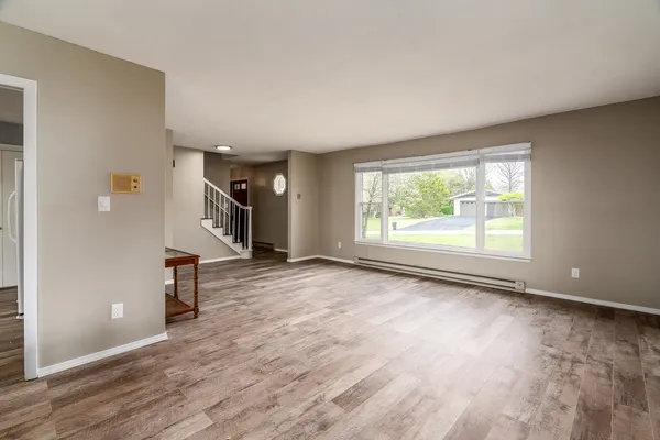 wooden floor in an empty room with a window