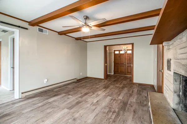 a view of an empty room with a fireplace