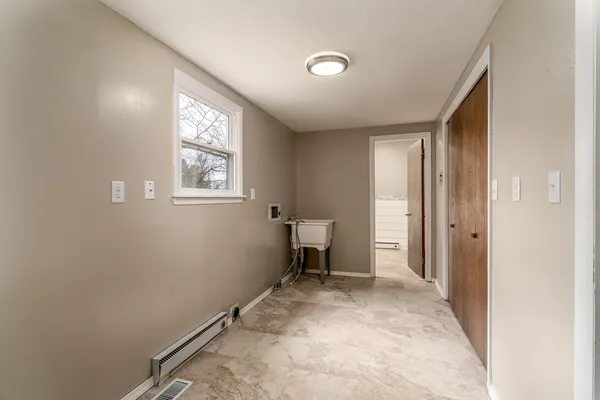 a view of room with a window and a chair