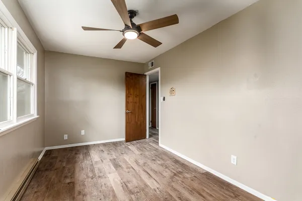 wooden floor in an empty room with a window