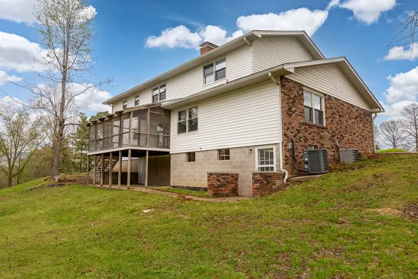 an aerial view of a house with a yard and lake view