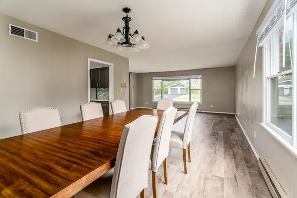 a view of a dining room with furniture window and wooden floor