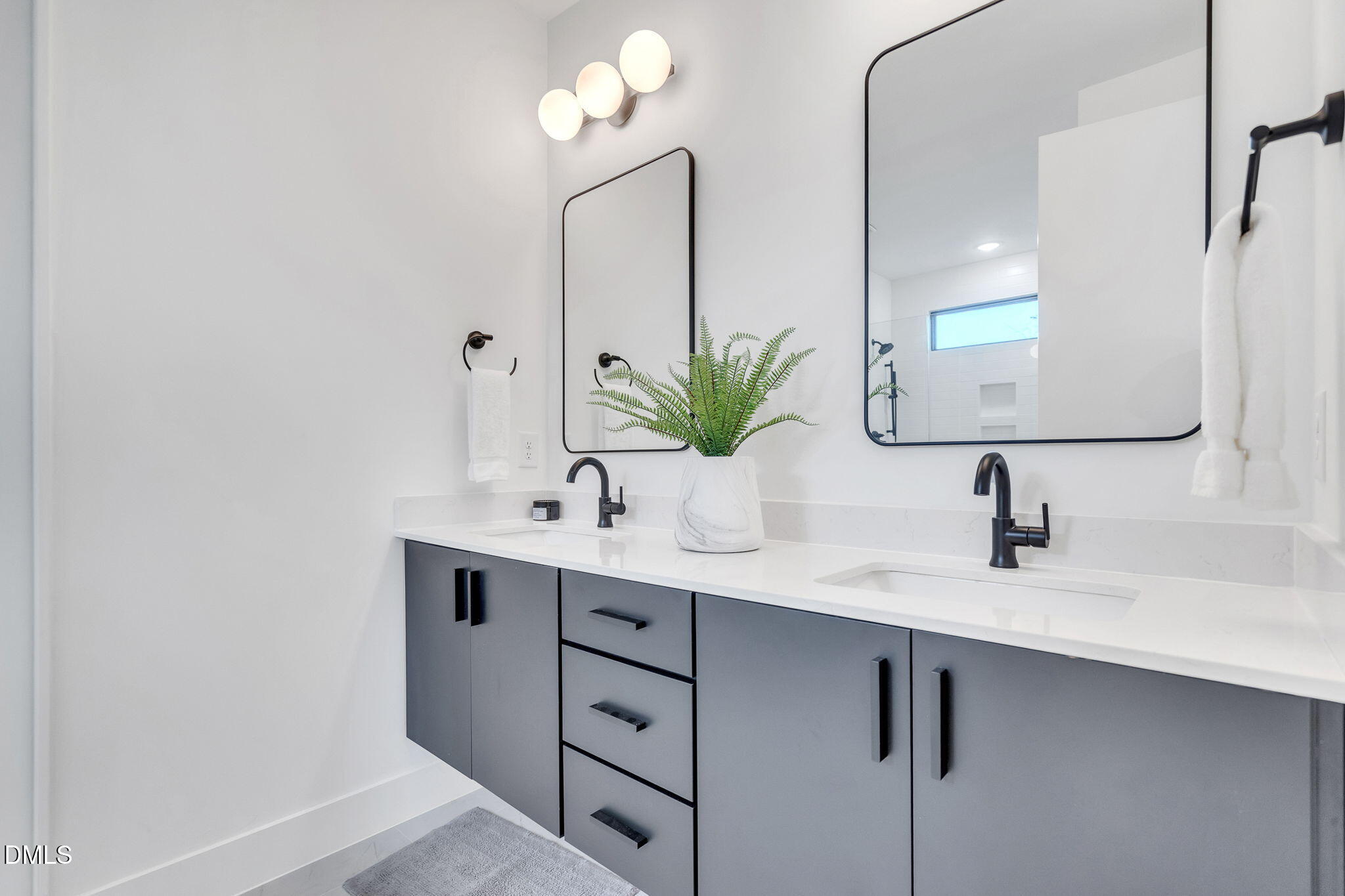 810 Culpepper Lane Raleigh, NC 27610 - Photo 17 of 31 a bathroom with a sink a mirror and a potted plant