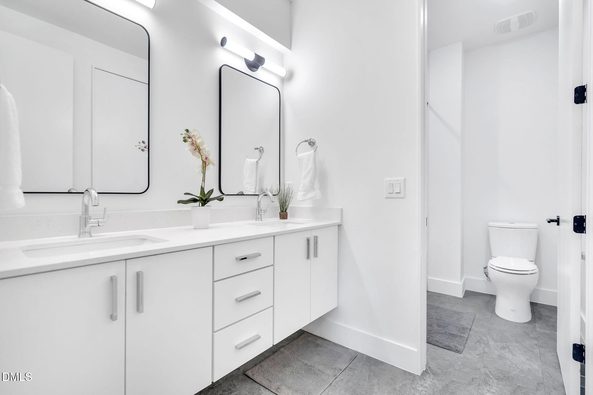 810 Culpepper Lane Raleigh, NC 27610 - Photo 23 of 31 a bathroom with a double vanity sink and a toilet