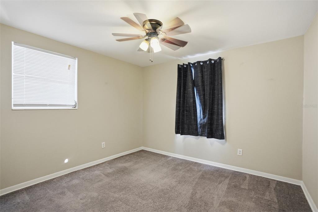9543 Century Drive Spring Hill, FL 34608 - Photo 13 of 25 an empty room with closet and windows