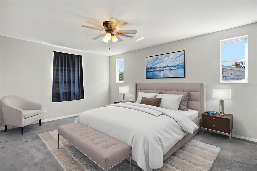 9543 Century Drive Spring Hill, FL 34608 - Photo 17 of 25 a bedroom with a large bed and a chandelier