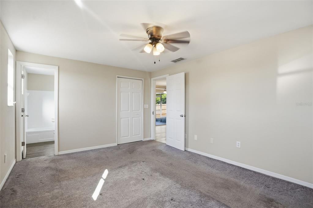 9543 Century Drive Spring Hill, FL 34608 - Photo 18 of 25 an empty room with closet and a chandelier fan