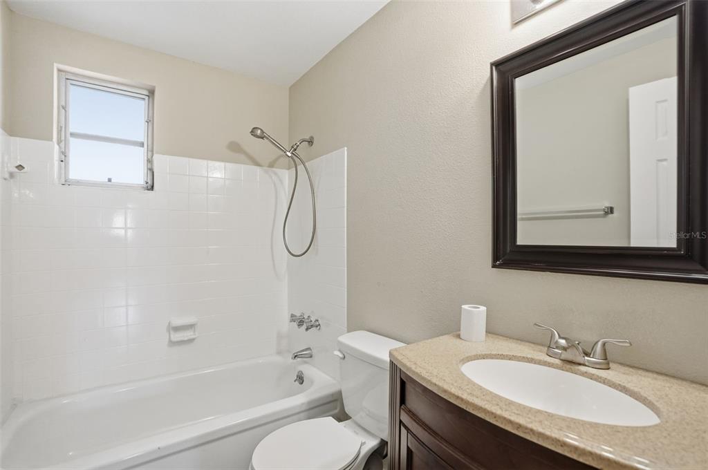 9543 Century Drive Spring Hill, FL 34608 - Photo 19 of 25 a bathroom with a granite countertop sink toilet and shower